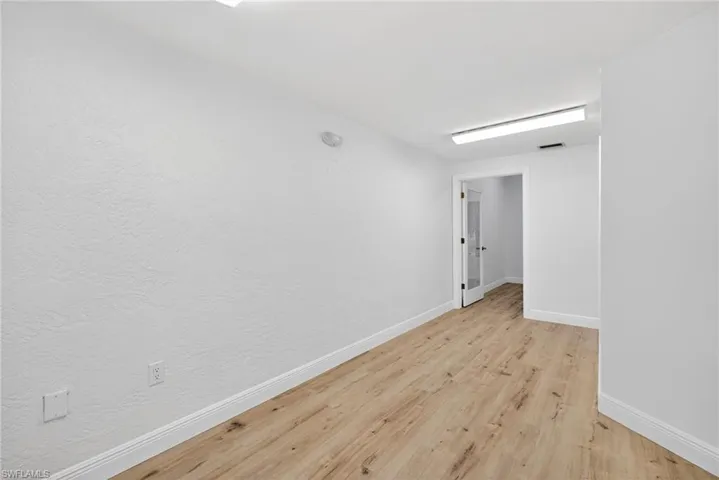Unfurnished room with baseboards and light wood-style flooring