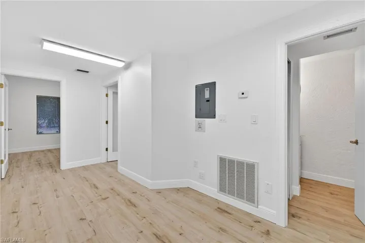 Spare room featuring light wood-style flooring and electric panel