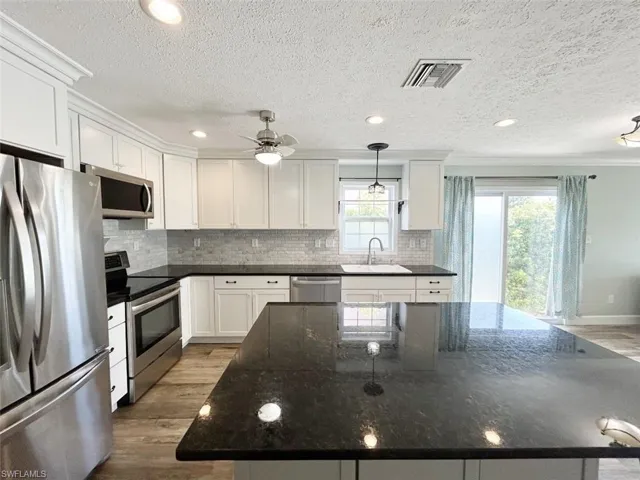Kitchen and glass sliding doors to backyard