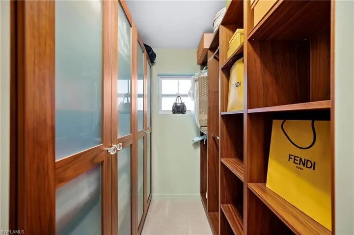 Walk in closet featuring carpet flooring