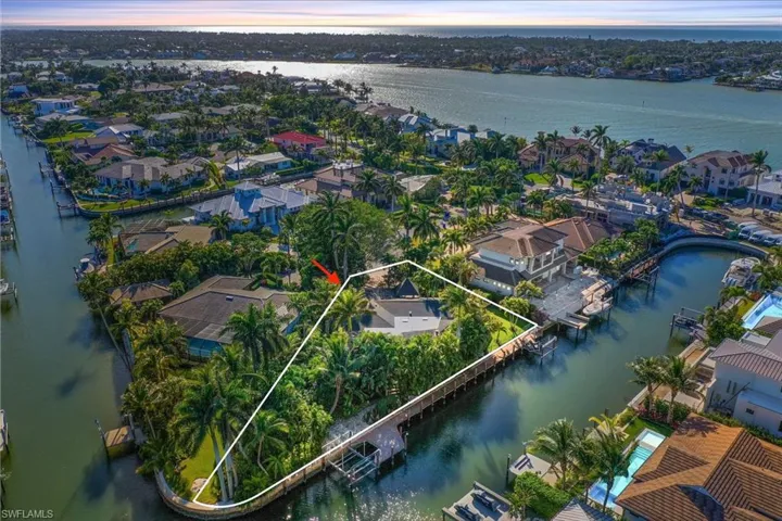 Aerial view at dusk featuring a water view