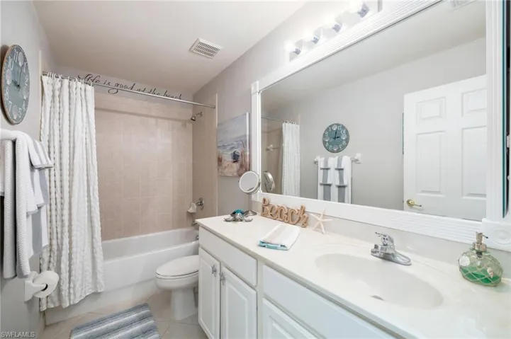 Guest Bathroom, with framed mirror and updated cabinet knobs