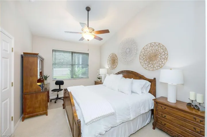 Primary bedroom with vaulted ceiling
