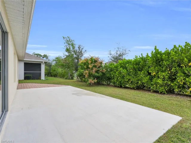 Patio and Rear Yard With Calusia Hedge And Privacy Landscaping