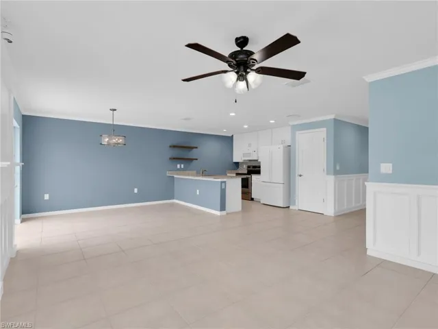 Great Room and Kitchen With White Shaker Cabinets, Island, Granite Countertops, Added Backsplash, New White GE Dishwasher, Microwave, And Refrigerator With Icemaker, and Stainless Steel Frigidaire Range With Self-Cleaning Oven