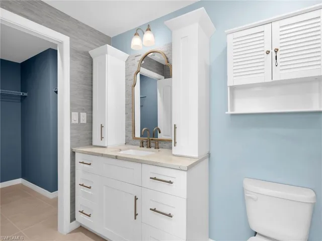 Primary Bathroom With With Renovated White Shaker Cabinets With Vanity Drawers and Cabinet Towers, Quartz Countertop, Added Backsplash, and Wallpaper