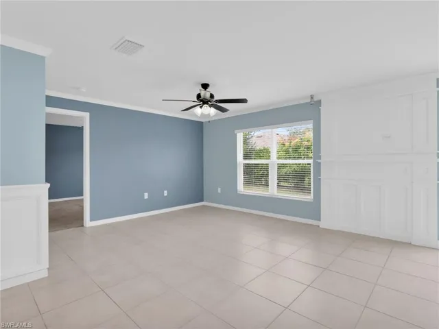 Dining Area With Crown Molding, Ceiling Fan, Tile Floors, Faux Window Blinds And Custom Woodwork Wall Feature