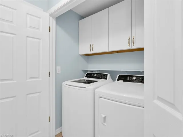 Laundry Room With GE Washer & Dryer and White Shaker Cabinetry