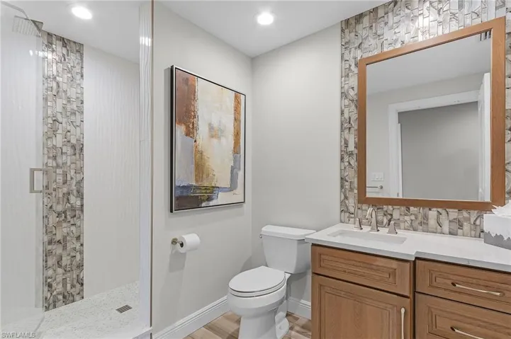 Bathroom with vanity, toilet, and walk in shower