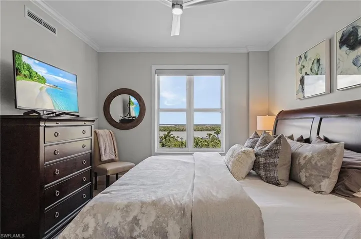 Bedroom with ornamental molding and ceiling fan