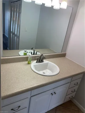 Bathroom featuring vanity and light tile patterned floors