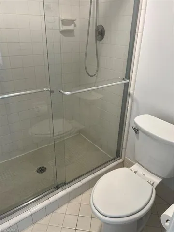 Full bath with a stall shower and light tile patterned floors