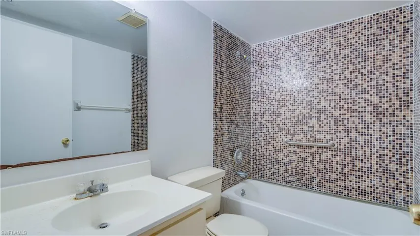 Bathroom with vanity and tub / shower combination