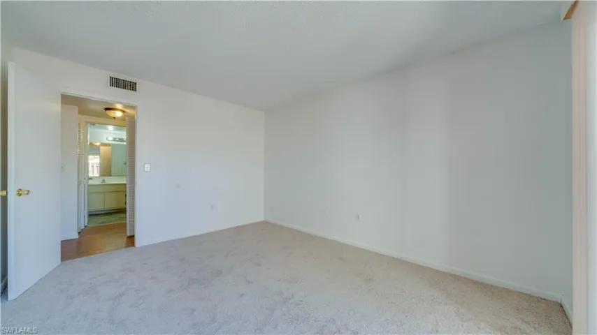 Unfurnished bedroom featuring carpet floors and baseboards