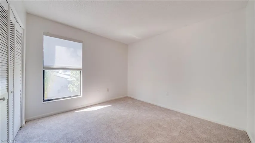 Unfurnished bedroom featuring a closet, carpet floors, and a textured ceiling