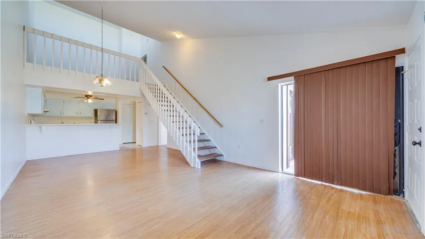 Entrance foyer featuring light wood-style floors, a ceiling fan, and vaulted ceiling