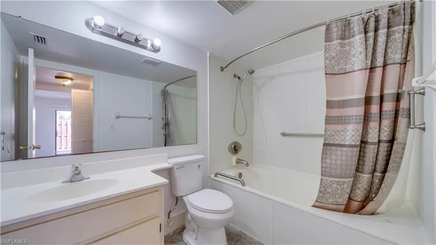 Bathroom with vanity and shower / tub combo