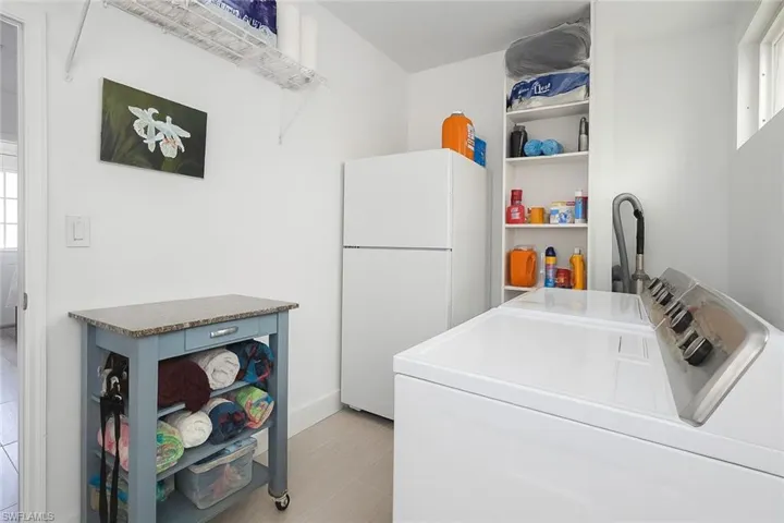 Washroom featuring washing machine and dryer