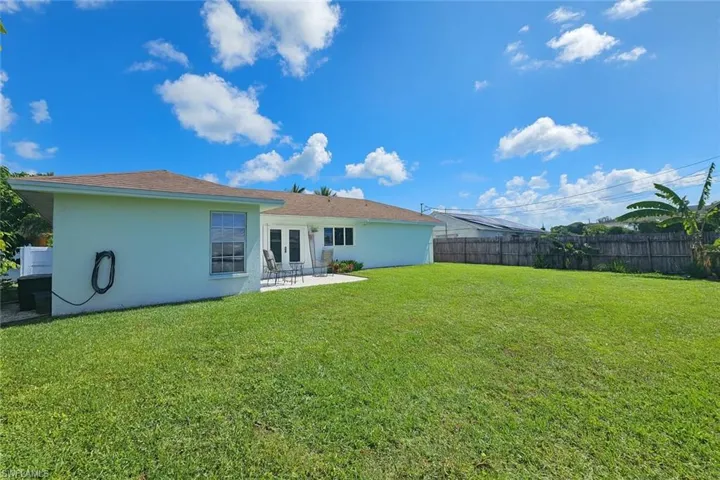 Back of house featuring french doors, stucco siding, and a patio