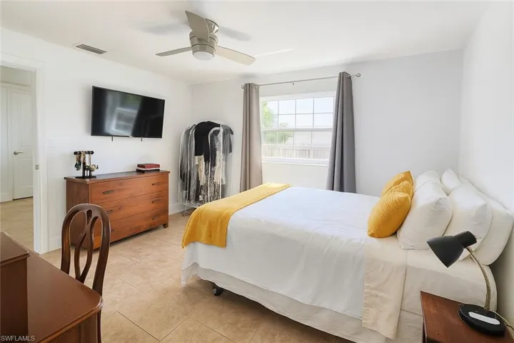 Bedroom featuring light tile patterned floors and ceiling fan