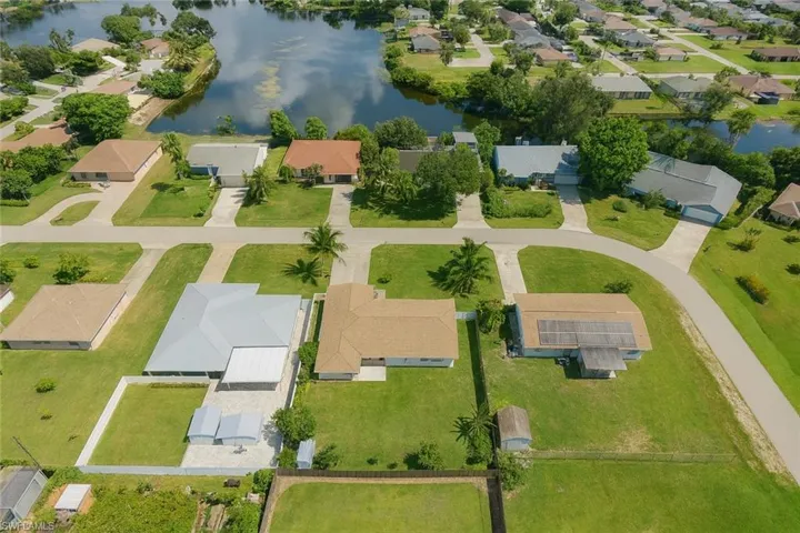 Aerial view of property's location featuring a large body of water and nearby suburban area