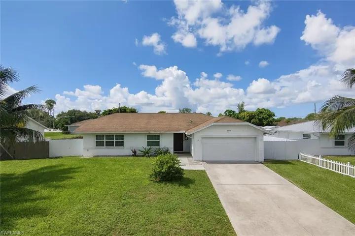 Ranch-style home featuring driveway, stucco siding, and a garage