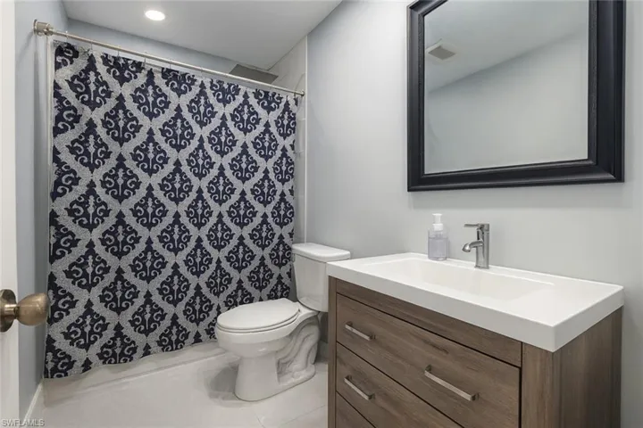Full bath with vanity, tile patterned floors, and a shower with curtain