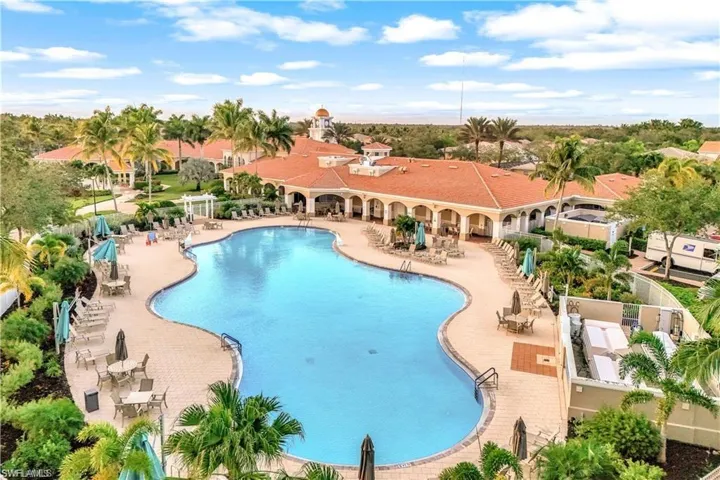 Resort pool with daily specials restaurant bar service and mature palm trees