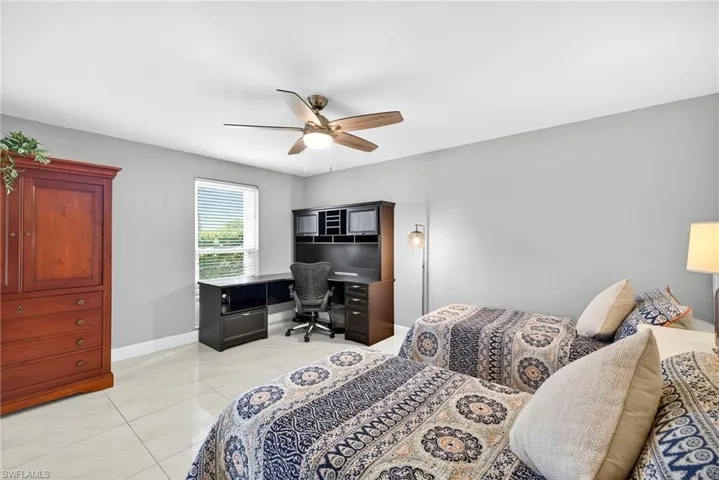 Bedroom featuring a desk and a ceiling fan