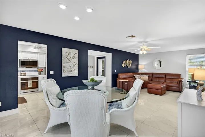 Dining space with a ceiling fan and recessed lighting