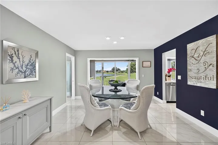 Dining room with light marble finish floors and baseboards