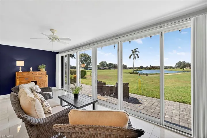 Sunroom / solarium featuring a water view