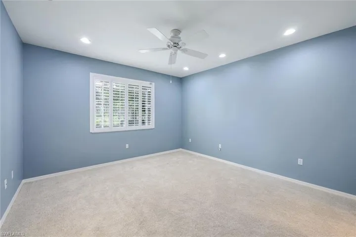 Spare room with carpet flooring and ceiling fan