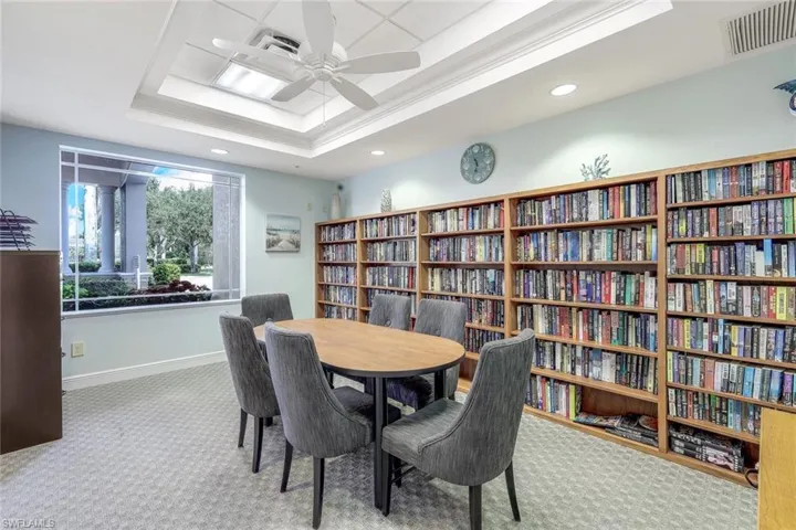 Dining space with a tray ceiling and carpet floors