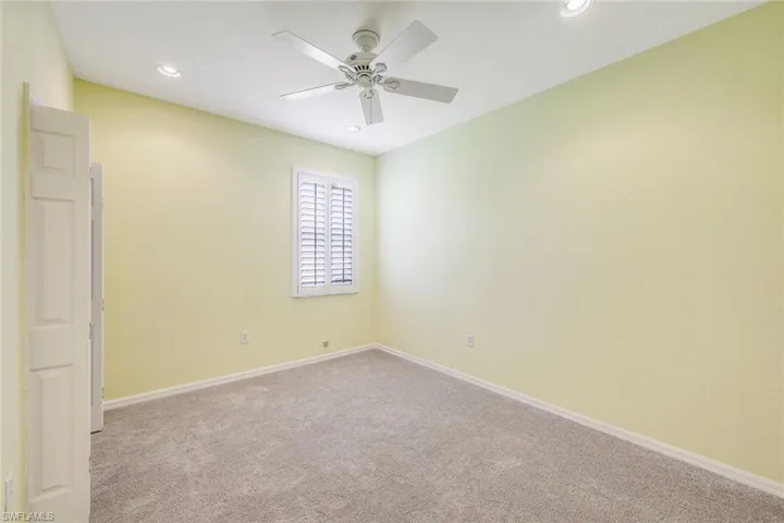 Carpeted spare room with ceiling fan