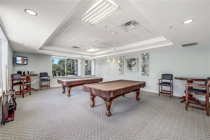Game room featuring billiards, a raised ceiling, carpet flooring, and ceiling fan