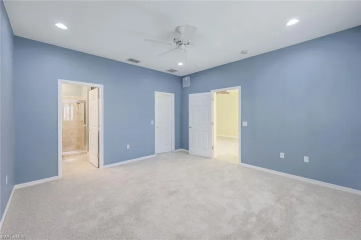 Unfurnished room with ceiling fan and light carpet