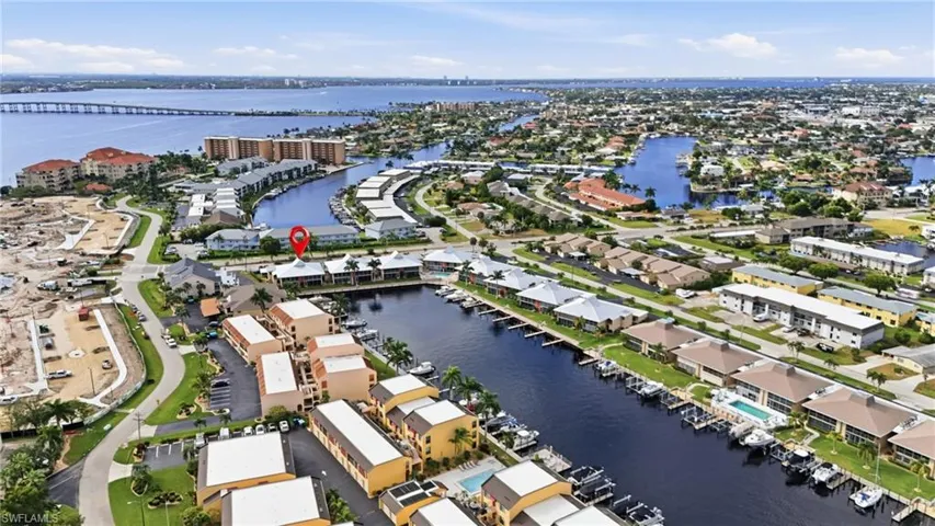 Aerial overview of property's location with a large body of water and nearby suburban area