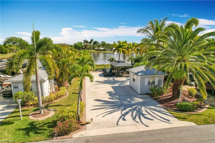 View of front of property featuring a gazebo, a water view, and a front yard