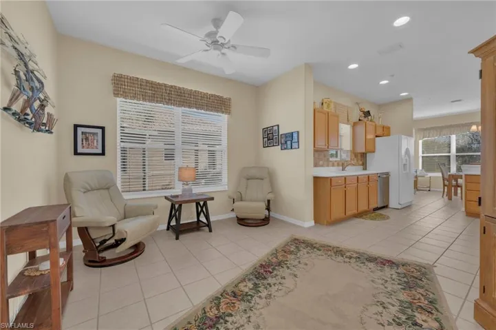 Living area featuring plenty of natural light, light tile patterned flooring, recessed lighting, and ceiling fan