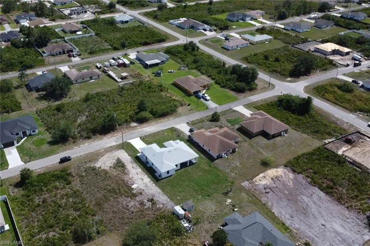 Aerial view of property's location featuring nearby suburban area