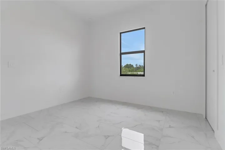 Unfurnished room featuring light marble finish floors