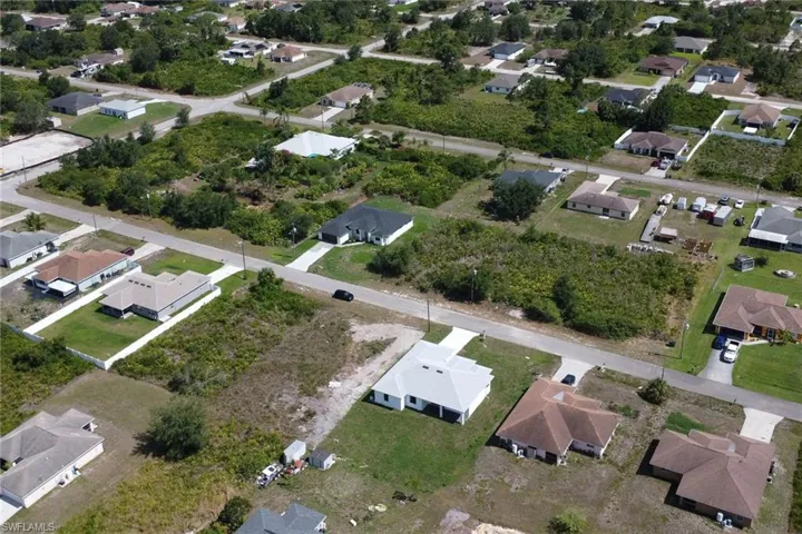 Aerial overview of property's location featuring nearby suburban area