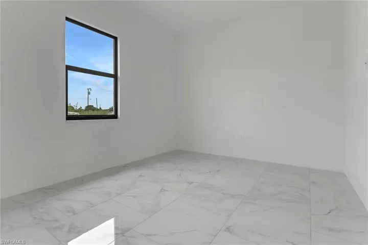 Empty room featuring marble look tile flooring