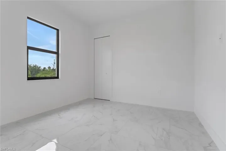 Empty room featuring light marble finish flooring