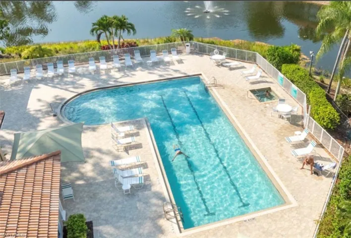 Community pool with a patio and a water view