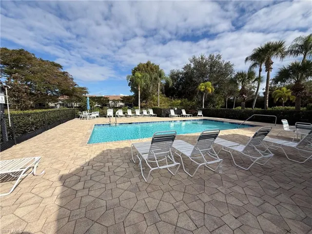 Community pool with a patio