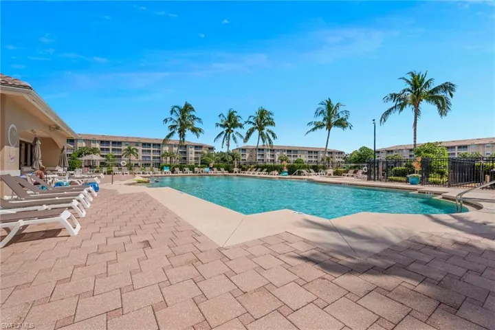 Community pool with a patio