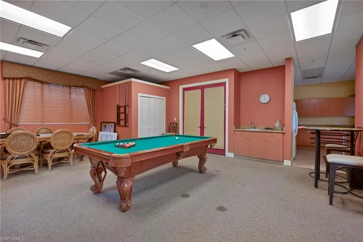 Rec room with light colored carpet, pool table, and a paneled ceiling