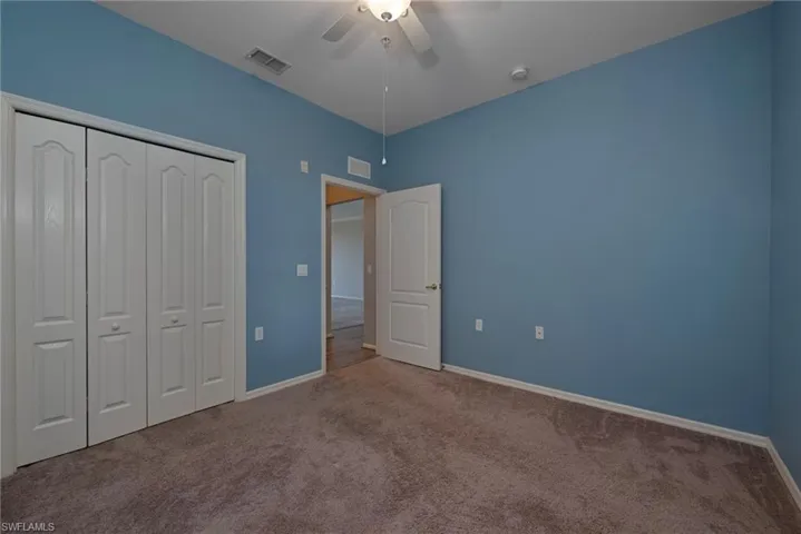 Unfurnished bedroom with carpet flooring, ceiling fan, and a closet